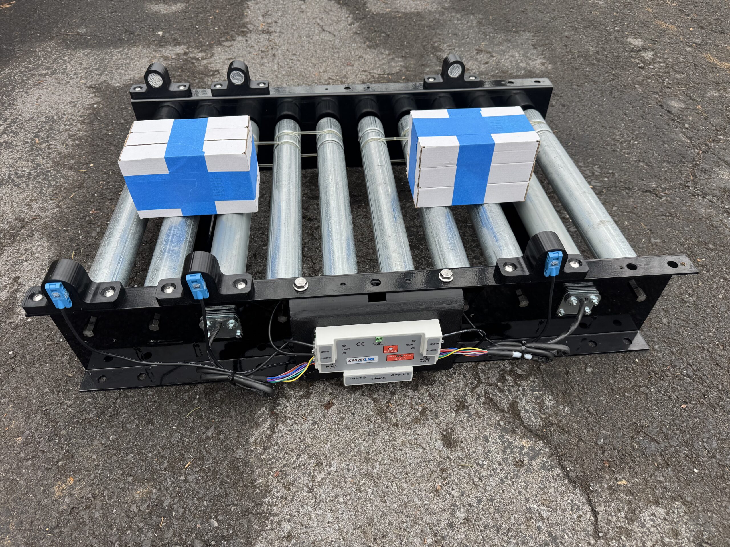 CGT MDR demo unit outdoors with two test cases sitting in separate accumulation zones, demonstrating zero-pressure accumulation