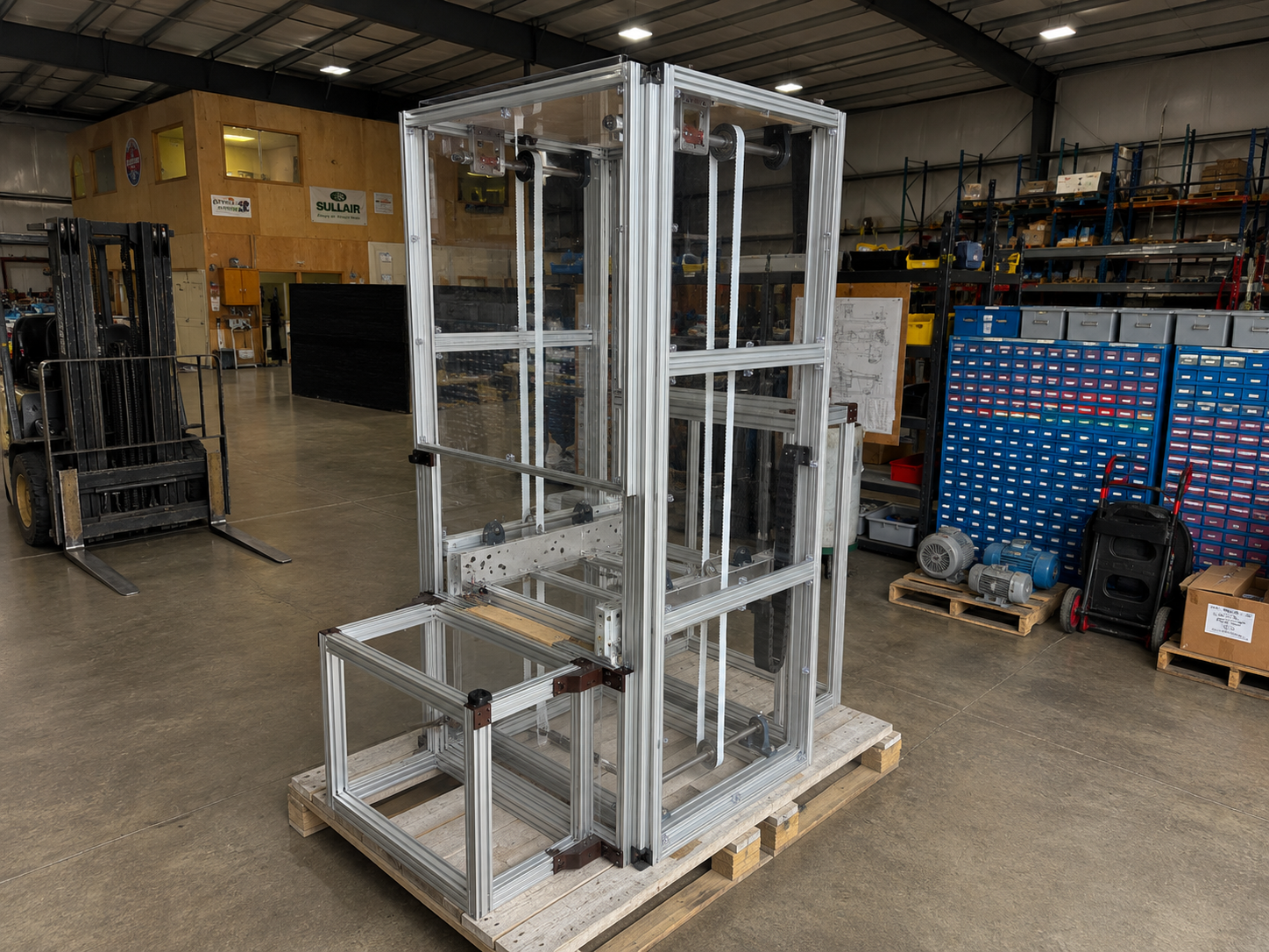 Custom vertical lift frame built in CGT shop, sitting on a pallet ready for shipment